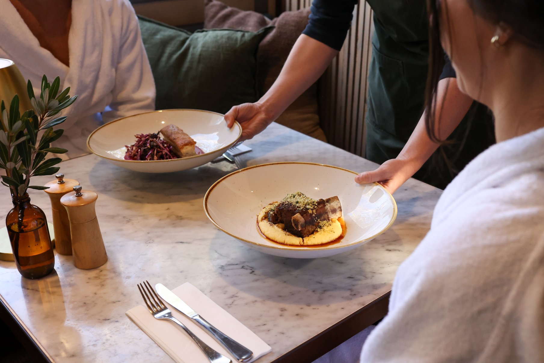 Two plates of food delivered to a table