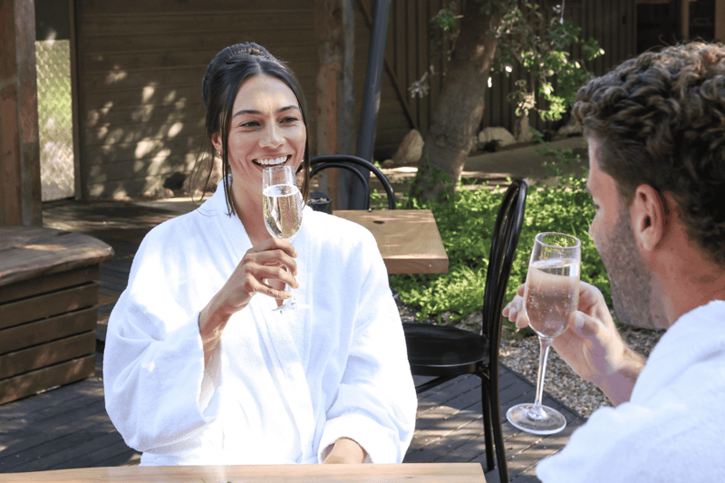 Two people drinking sparkling wine in the Courtyard