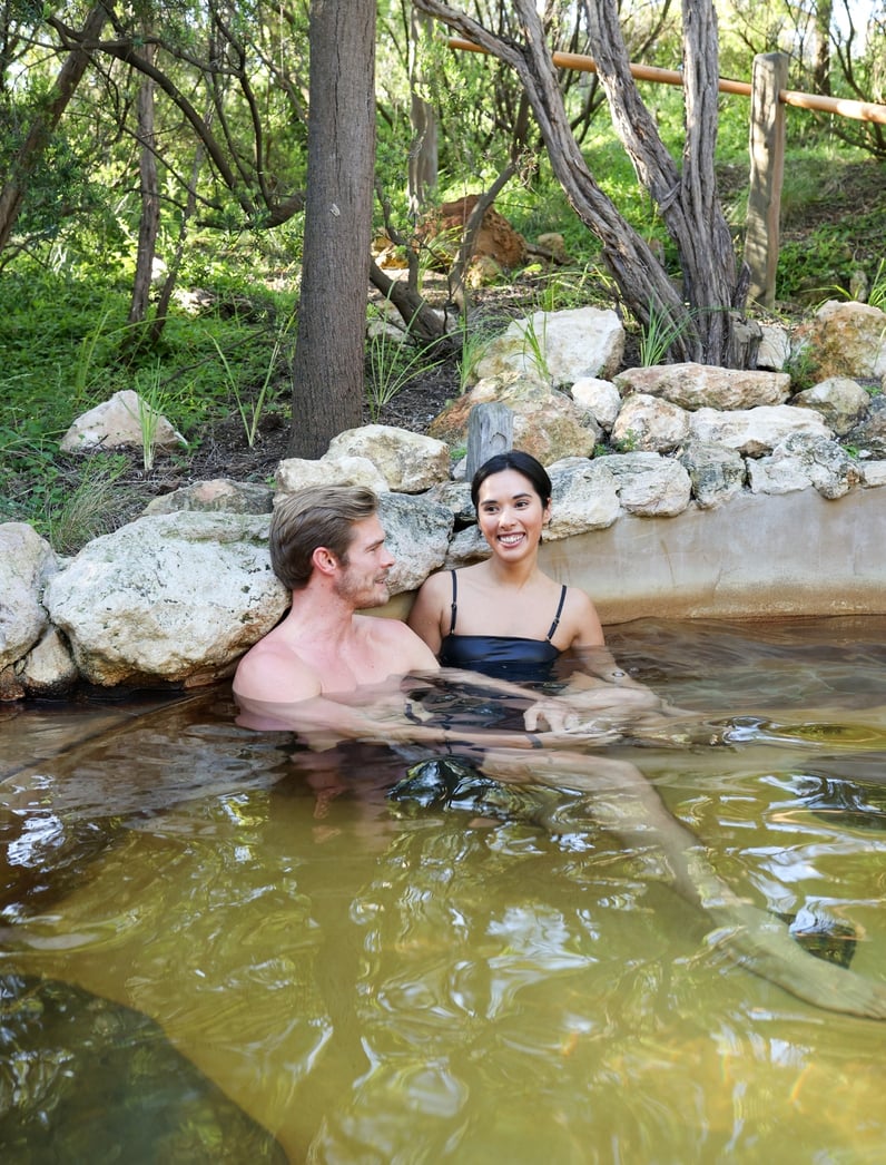 Two people bathing in hot springs
