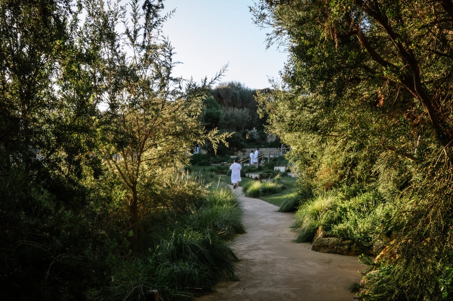 People in white robes walking through the Amphitheatre