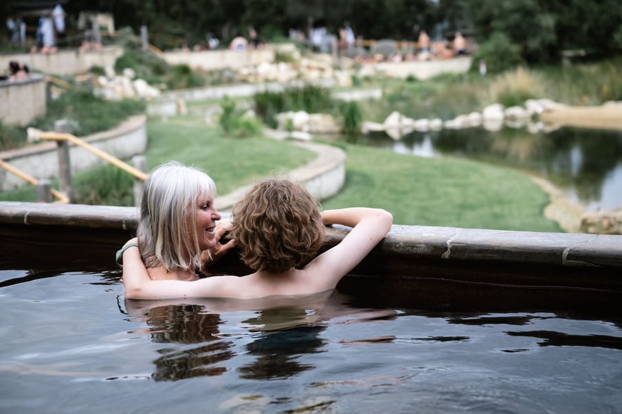 A grandmother and grandson bathing in hot springs