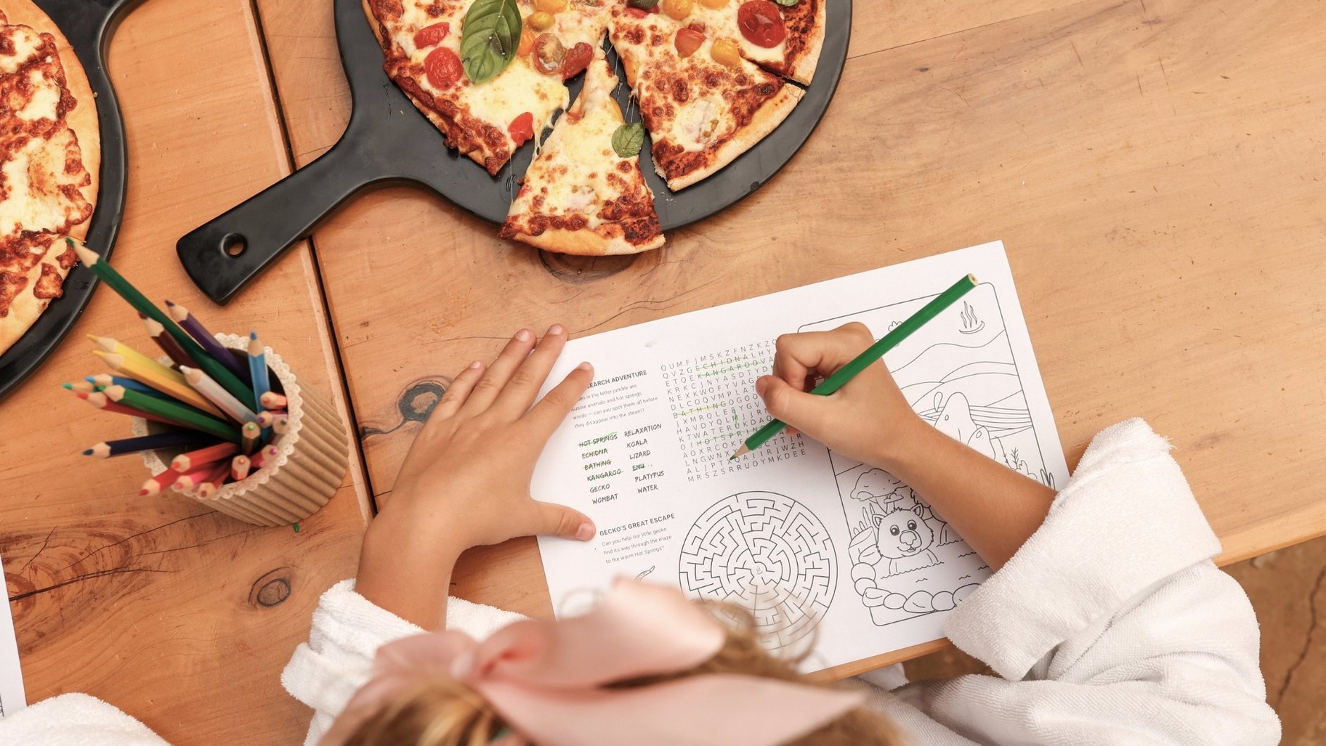 A young child colouring in at the Amphitheatre Cafe