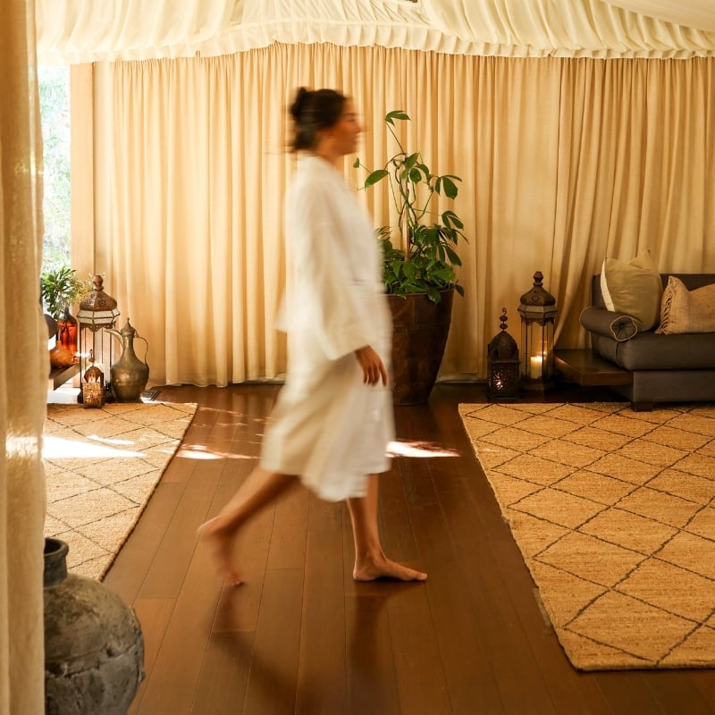 A woman in a robe walking through the relaxation lounge
