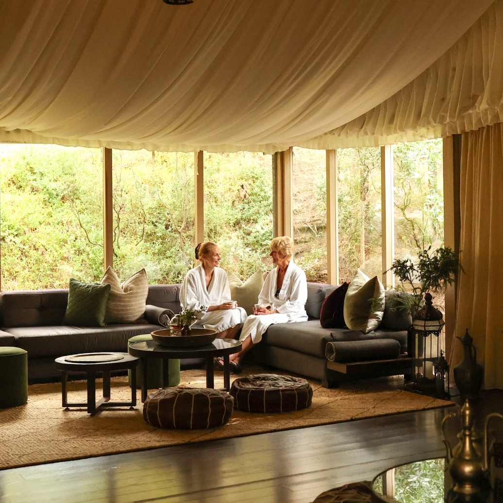 A mother and daughter in the Arabian Marquee waiting for their treatments