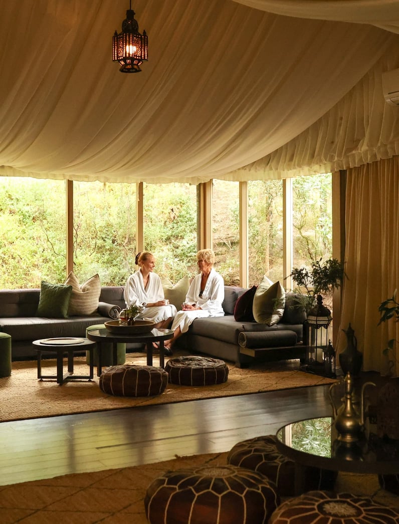 Two people sitting in the Arabian Marquee