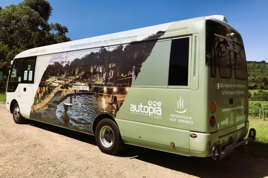A bus with Peninsula Hot Springs wrapping