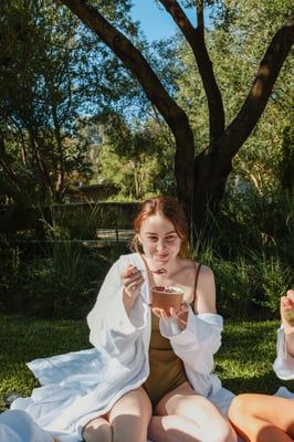 A young girl eating an Acai bowl
