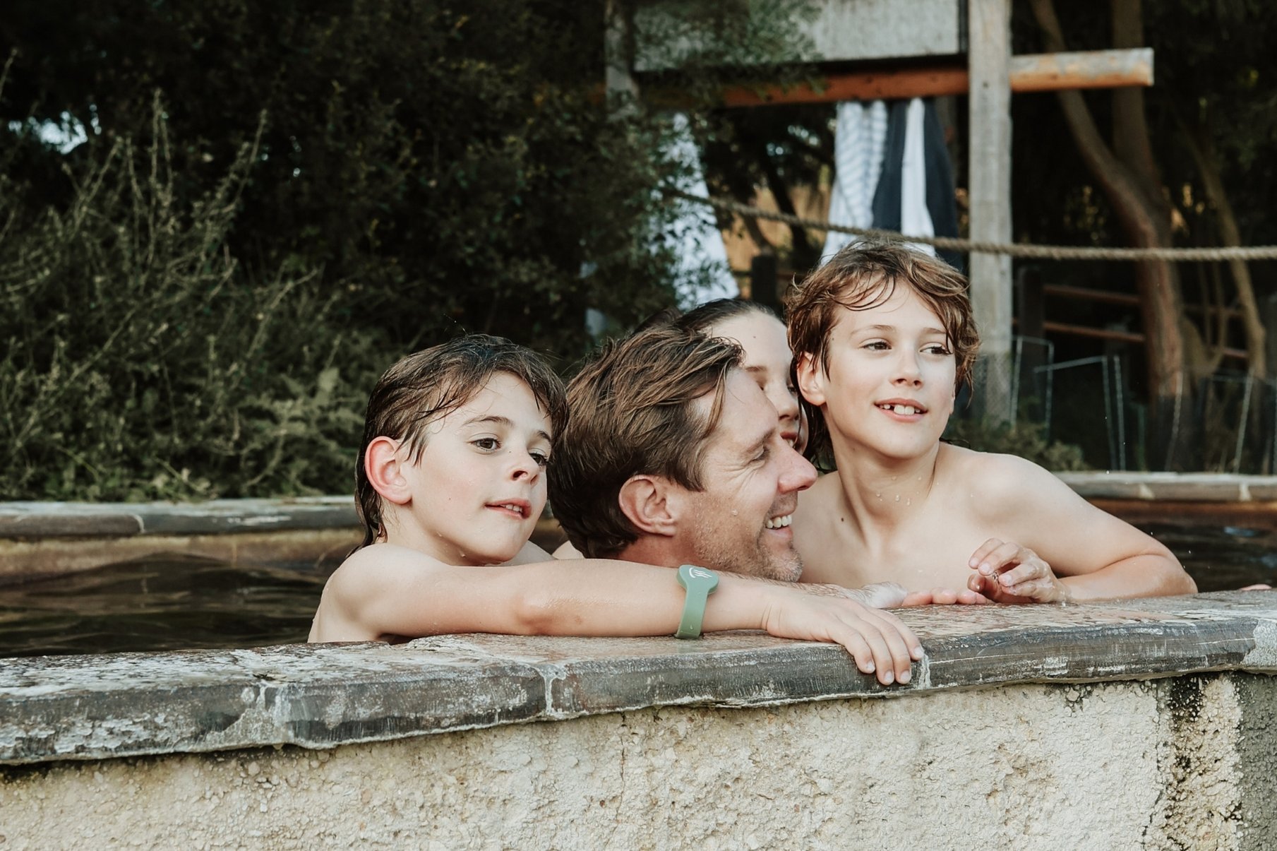 A father with his children bathing in hot springs