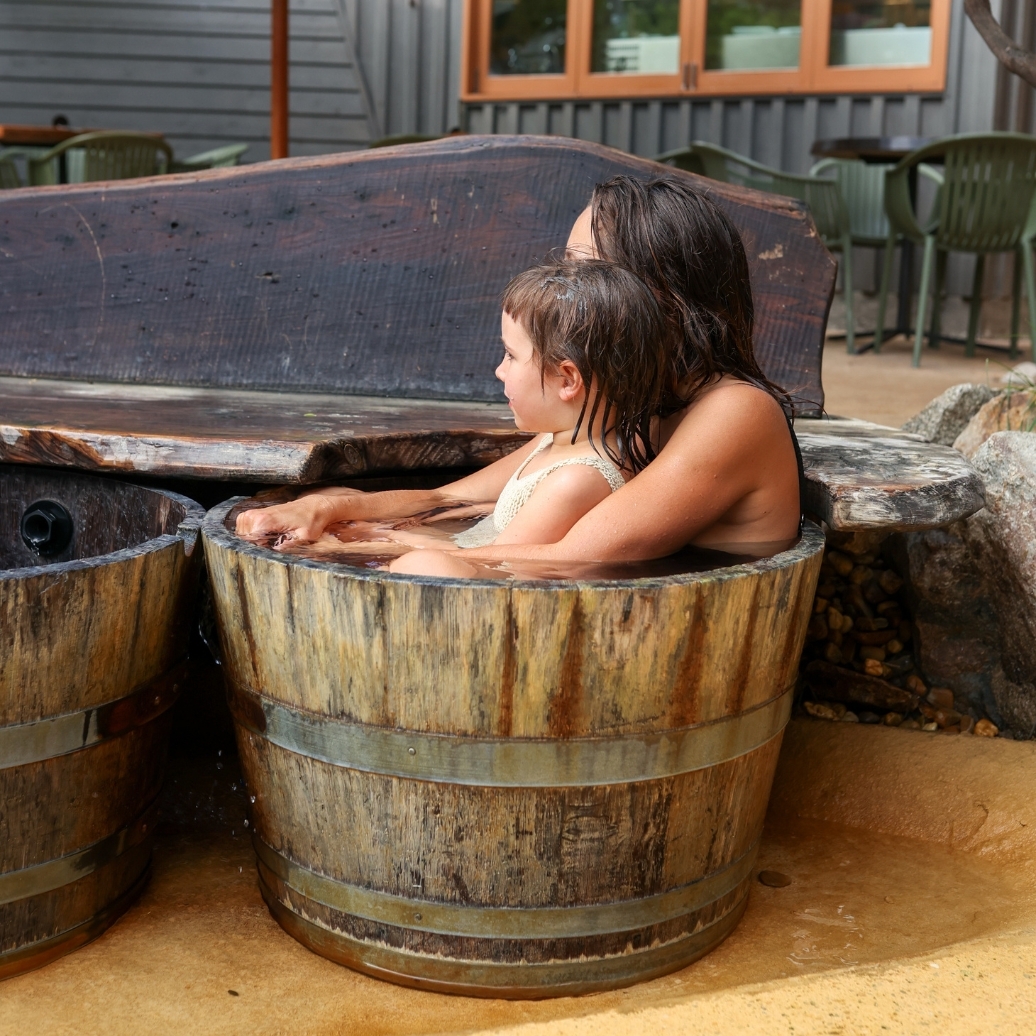 A mother and daughter in a bathing bucket