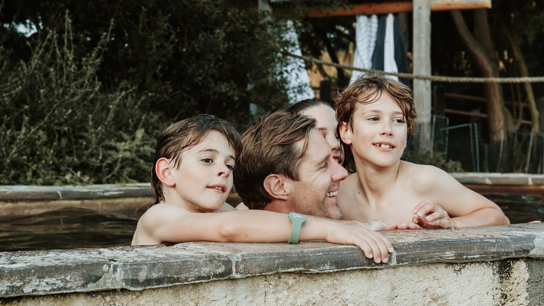 A father and kids bathing in hot springs