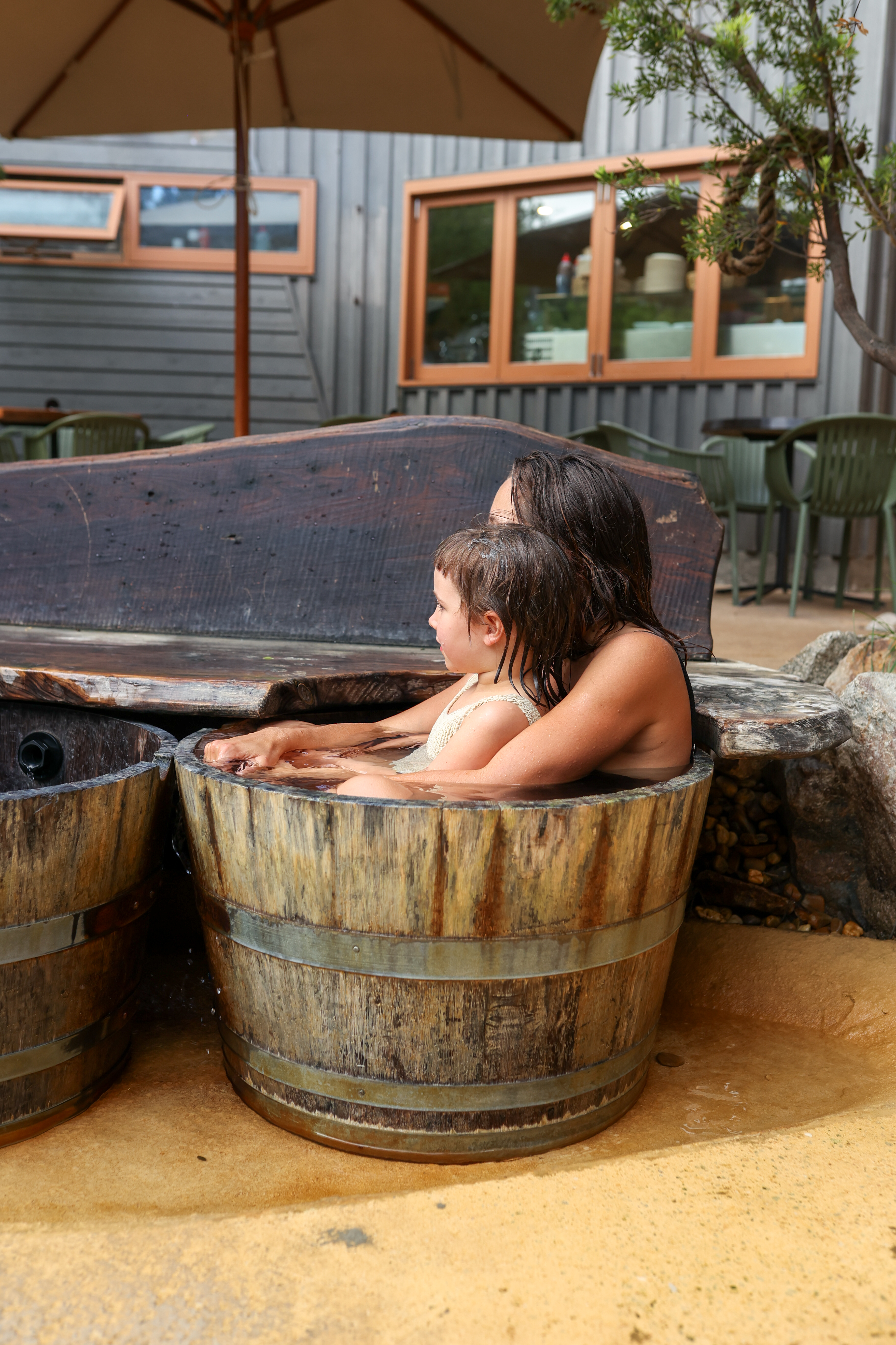 A mother and child in a bucket of geothermal water