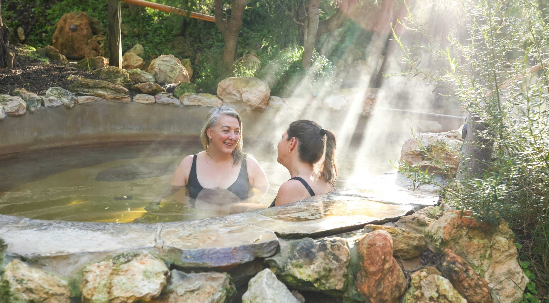 Two women bathing in hot springs