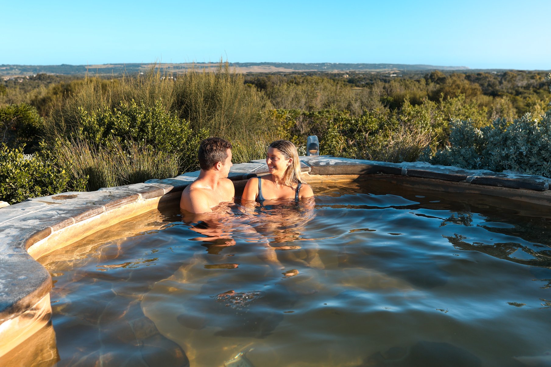 Two people bathing in hot springs