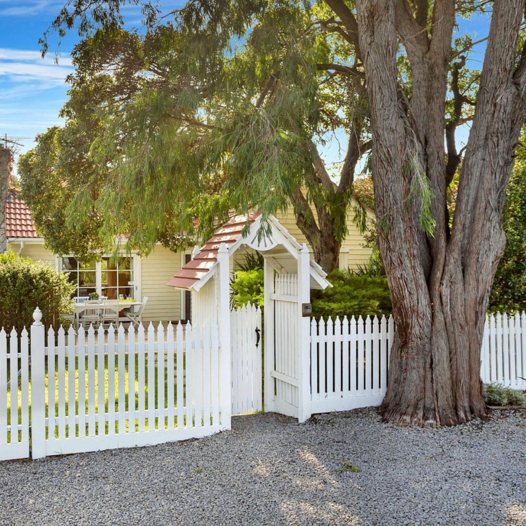 The exterior view of a small white cottage