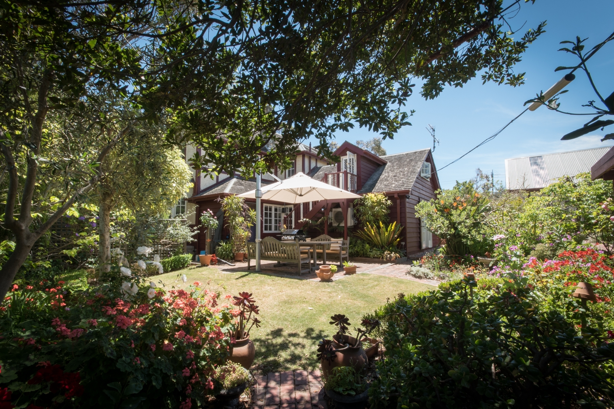 The exterior of a brown brick, multi story house
