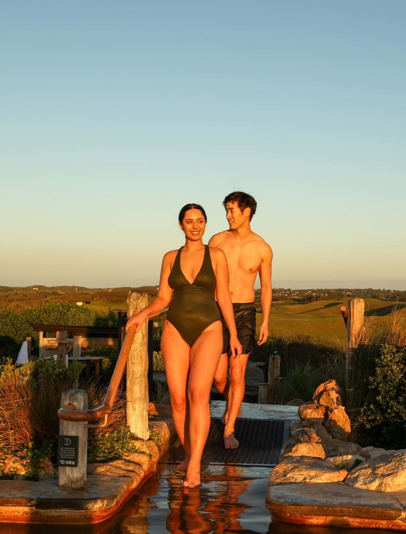 Two people walking from Hilltop Pool