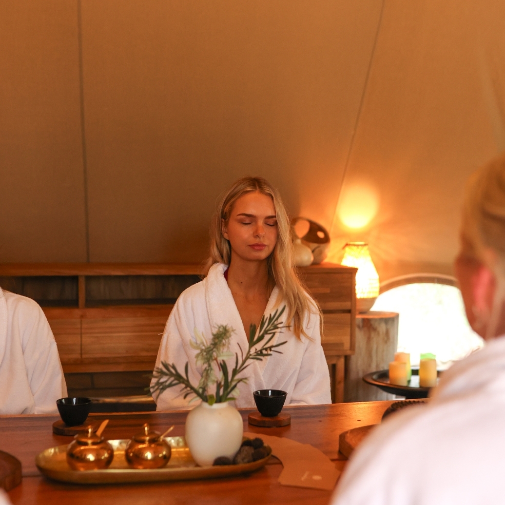 A woman in a robe doing the Cacao Circle