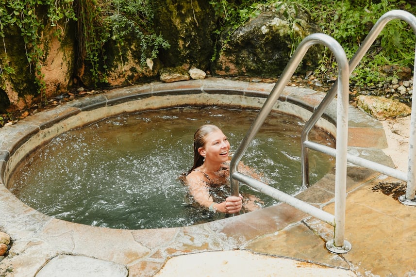 A young girl who has just dived into a cold pool