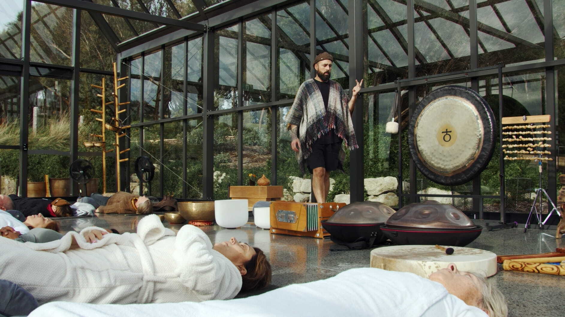 Dan Byrne facilitating a Sound Healing experience in the Glasshouse.