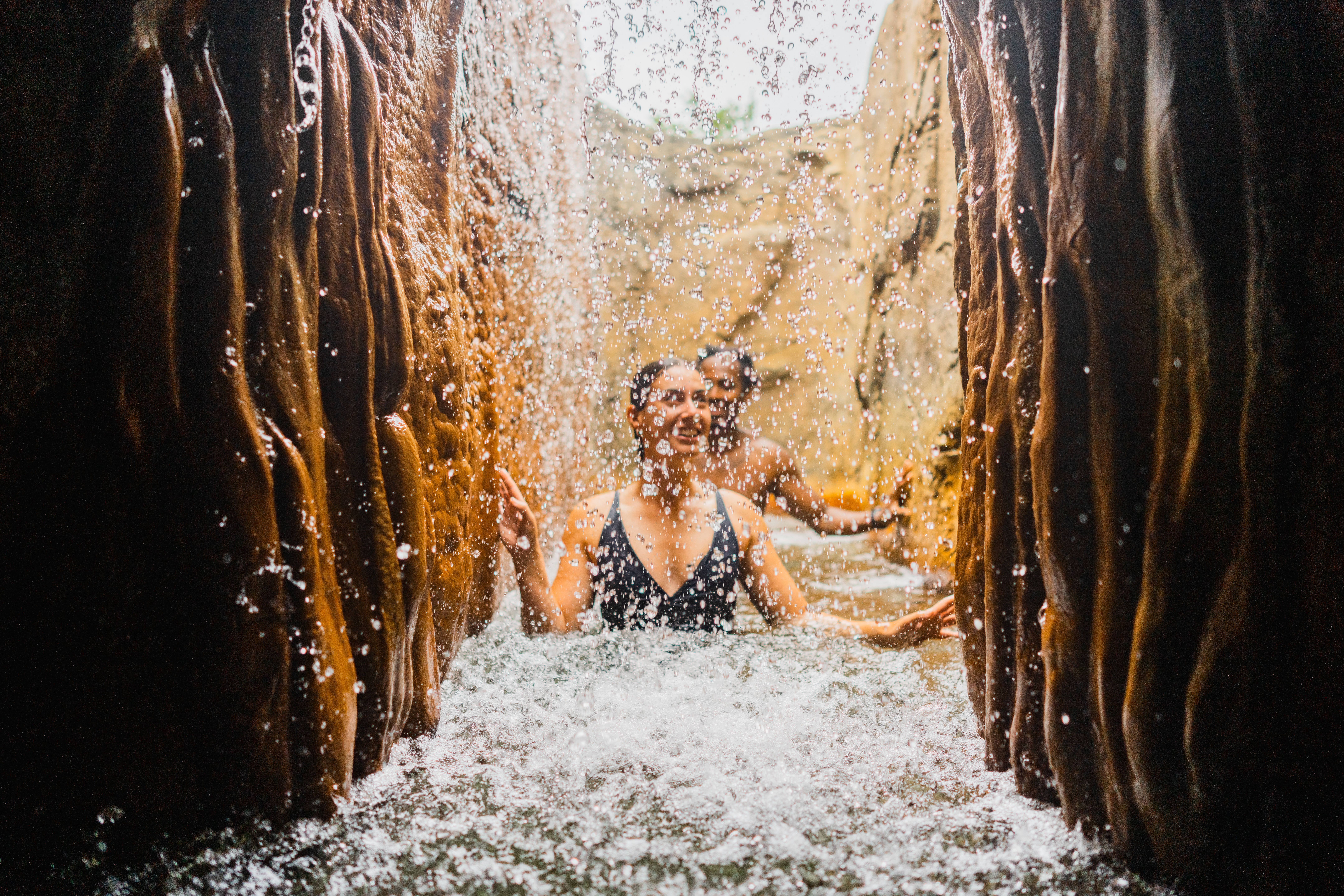 Two people walking through hot springs at Deep Blue Spa &amp; Baths