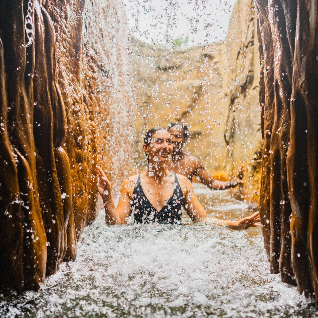 Two people walking through hot springs at Deep Blue Spa and Baths