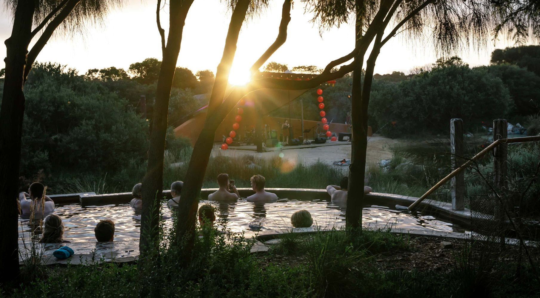 People bathing and watching the stage