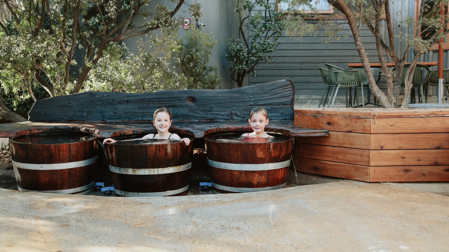 Two young children in the bathing barrels