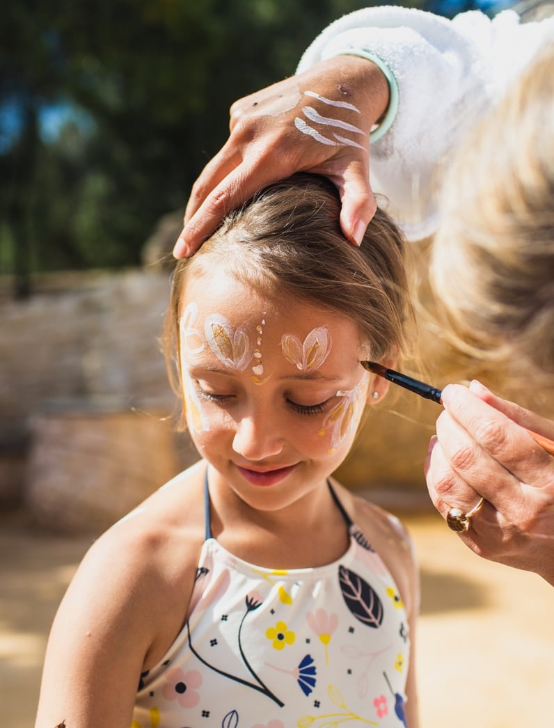 A young girl taking part in family body clay