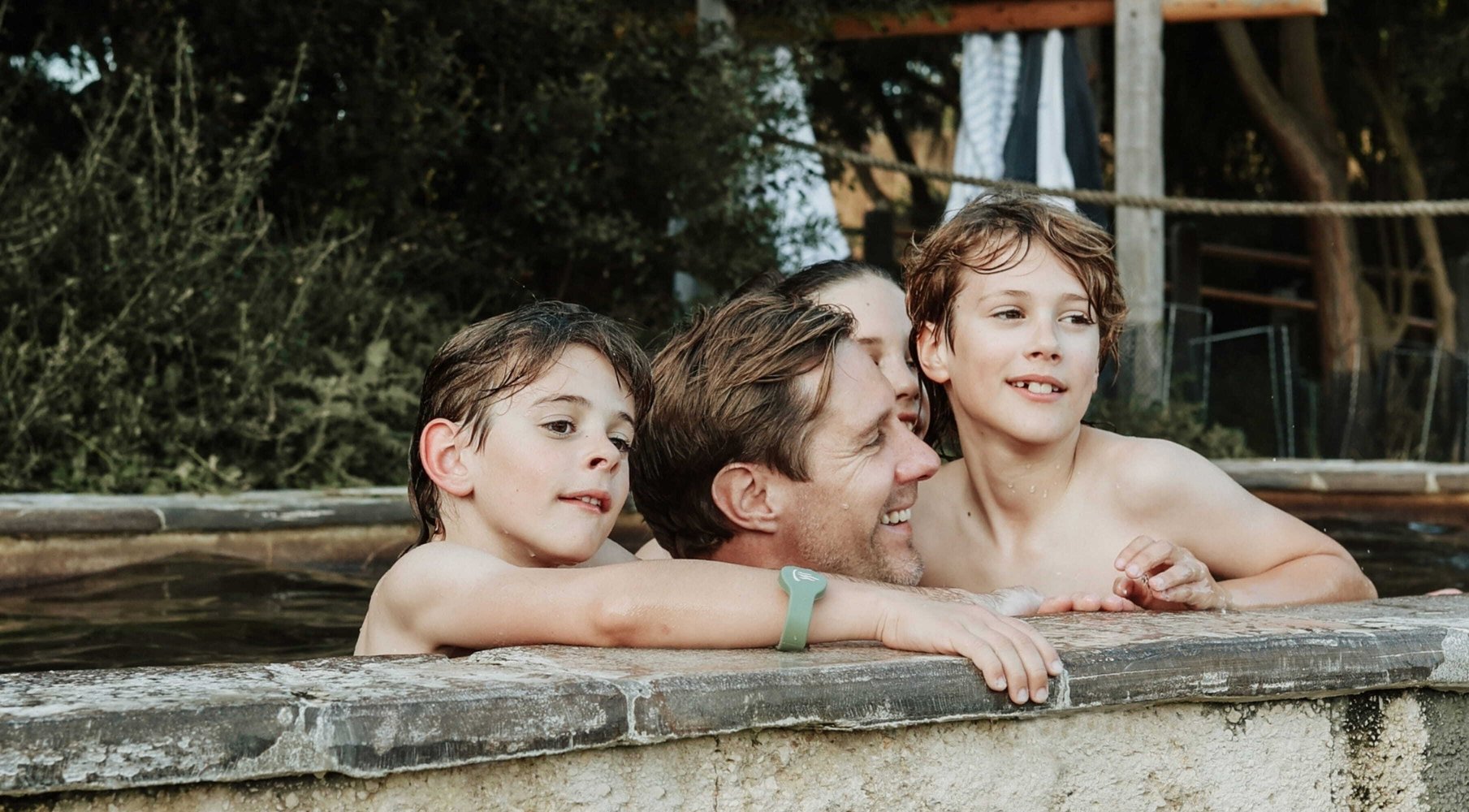 A father and kids bathing in hot springs