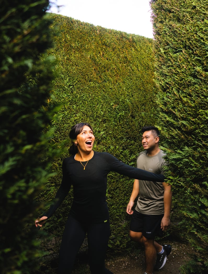 Two people walking through a maze