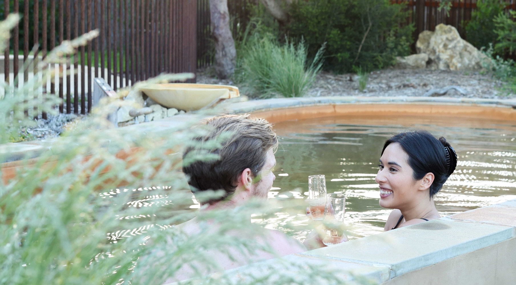 Two people bathing in hot springs