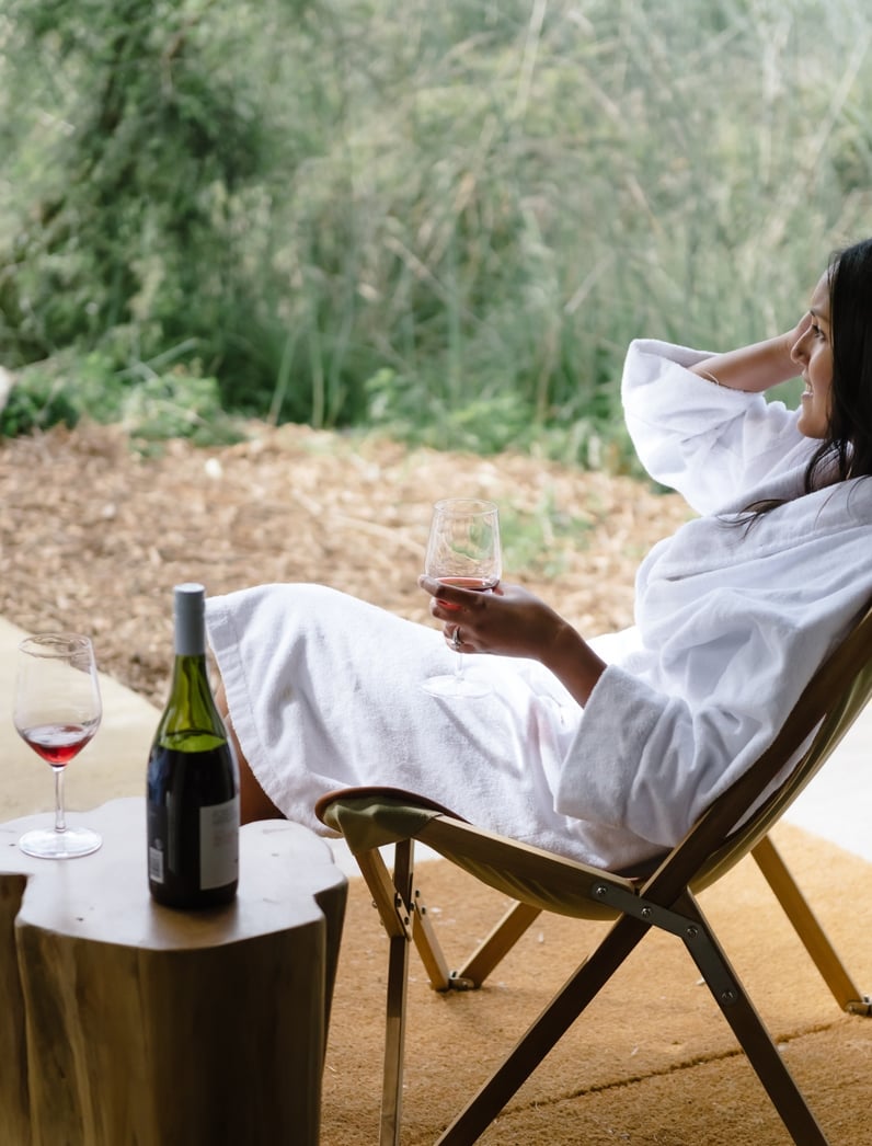 A woman in a deck chair with a white robe on
