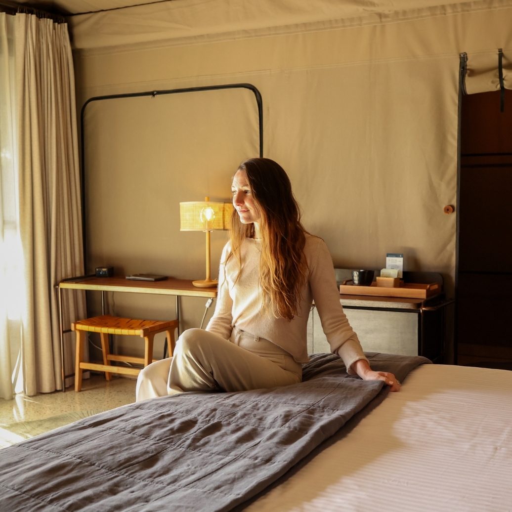 A woman sitting on a Glamping tent