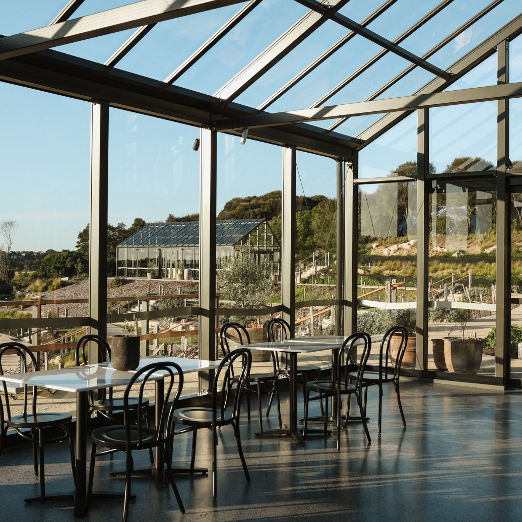 Tables and chairs set up in the Glasshouse