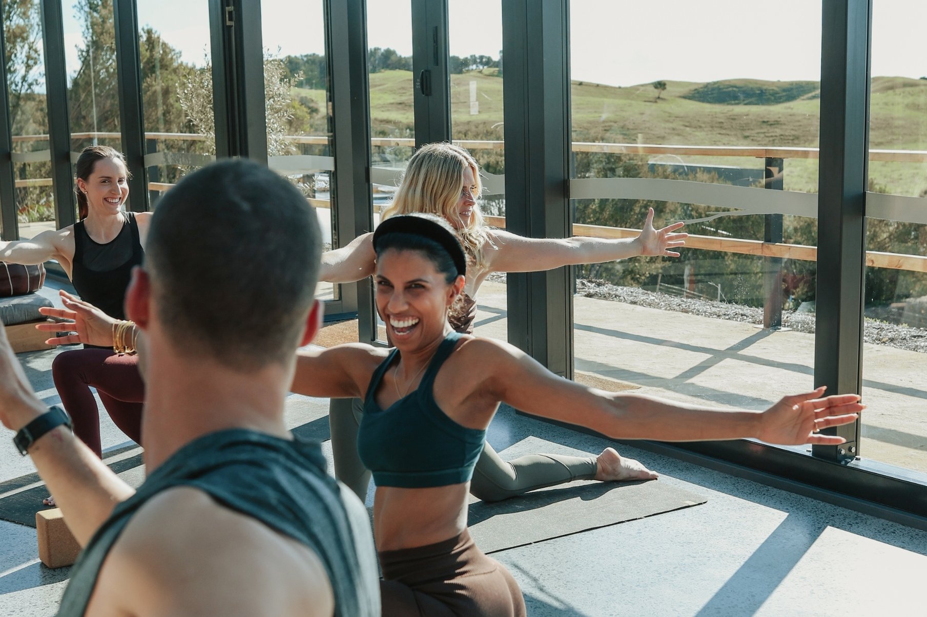 A group doing Yoga in the Glasshouse