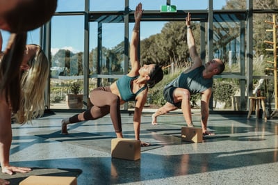 A group of people doing yoga in the Glasshouse