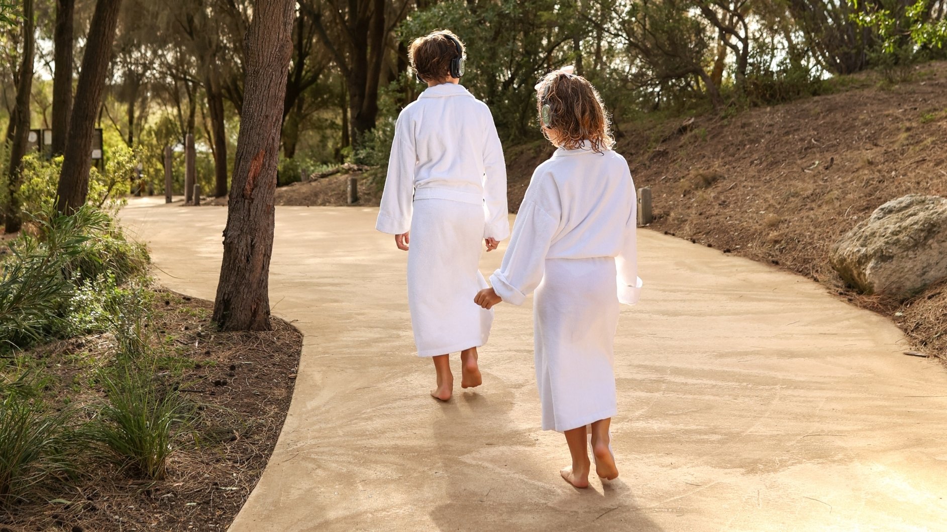 Two kids in white robes doing the Global Sound Bathing Journey