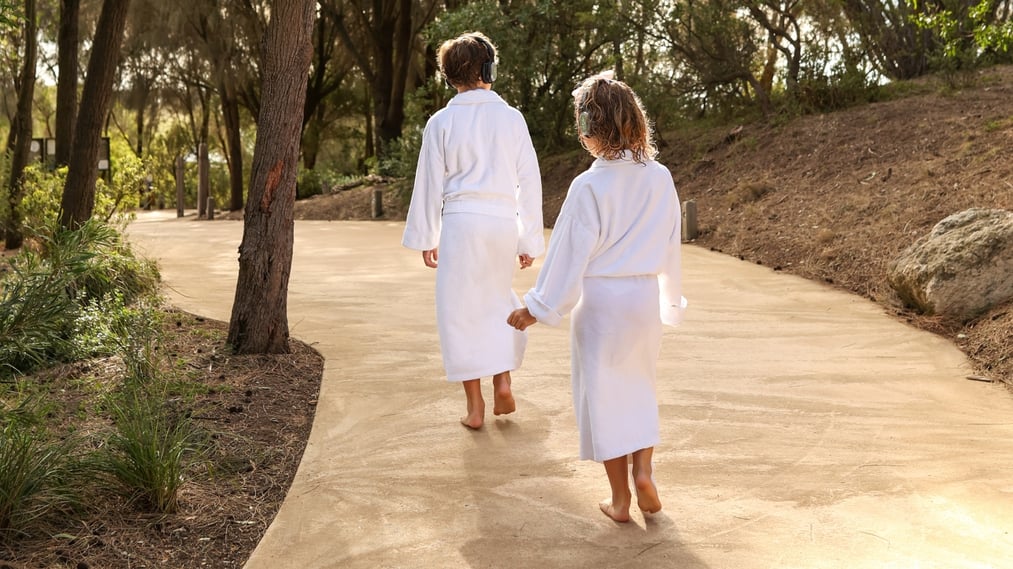 Two kids in white robes doing the Global Sound Bathing Journey