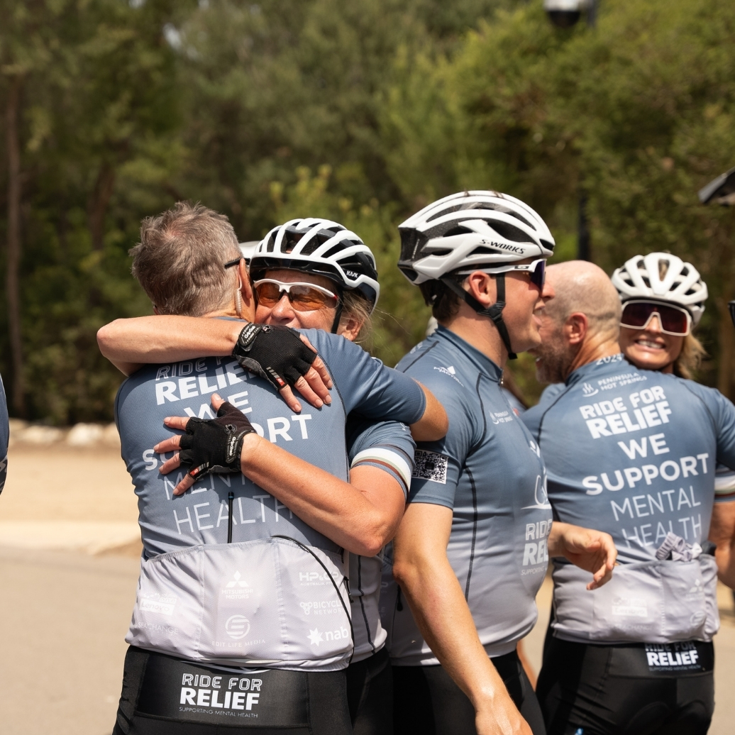 Particpants of Ride for Relief hugging post race