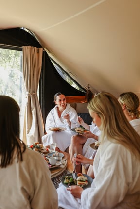 A group of people in white robes, dining in the Moroccan Pavilion