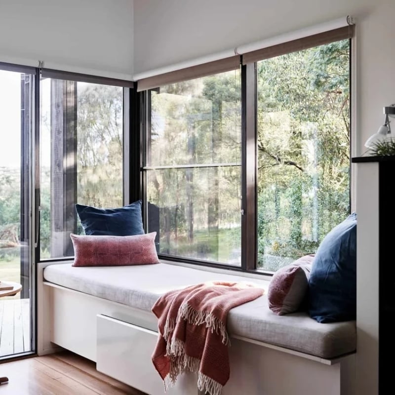 A sun lounge looking out to farm land