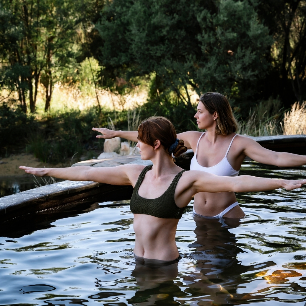 Two people doing hot springs yoga