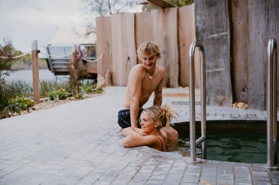 A young man and woman in the cold plunge pool at Metung Hot Springs