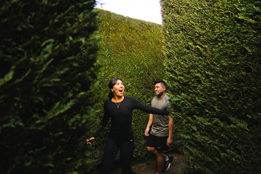 Two people walking through a maze