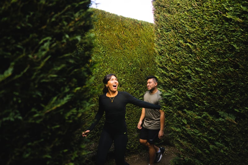 Two people walking through a maze