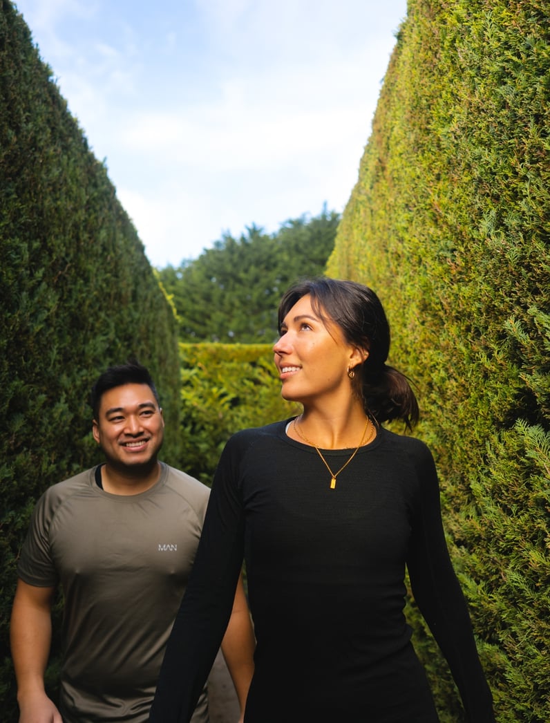 Two people walking through a maze