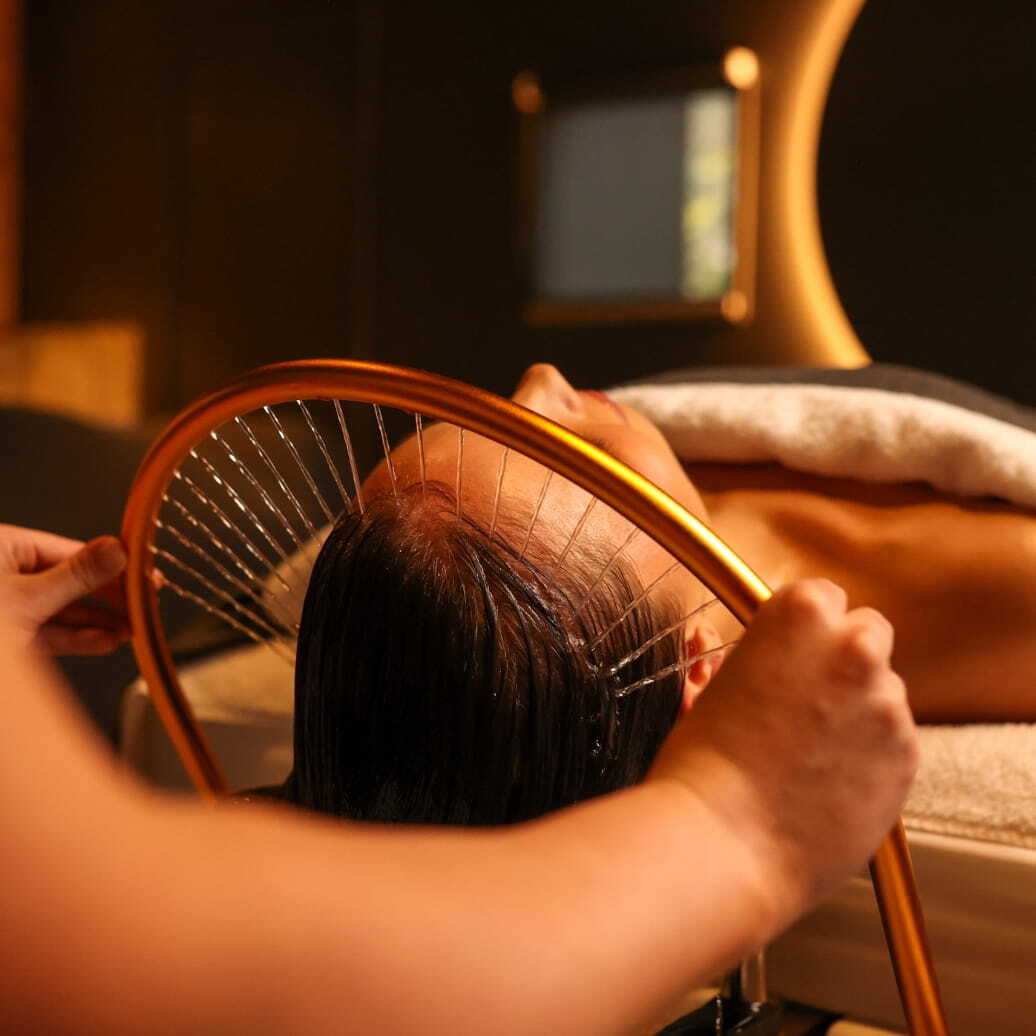 A woman receiving a Peninsula Head Spa spa treatment