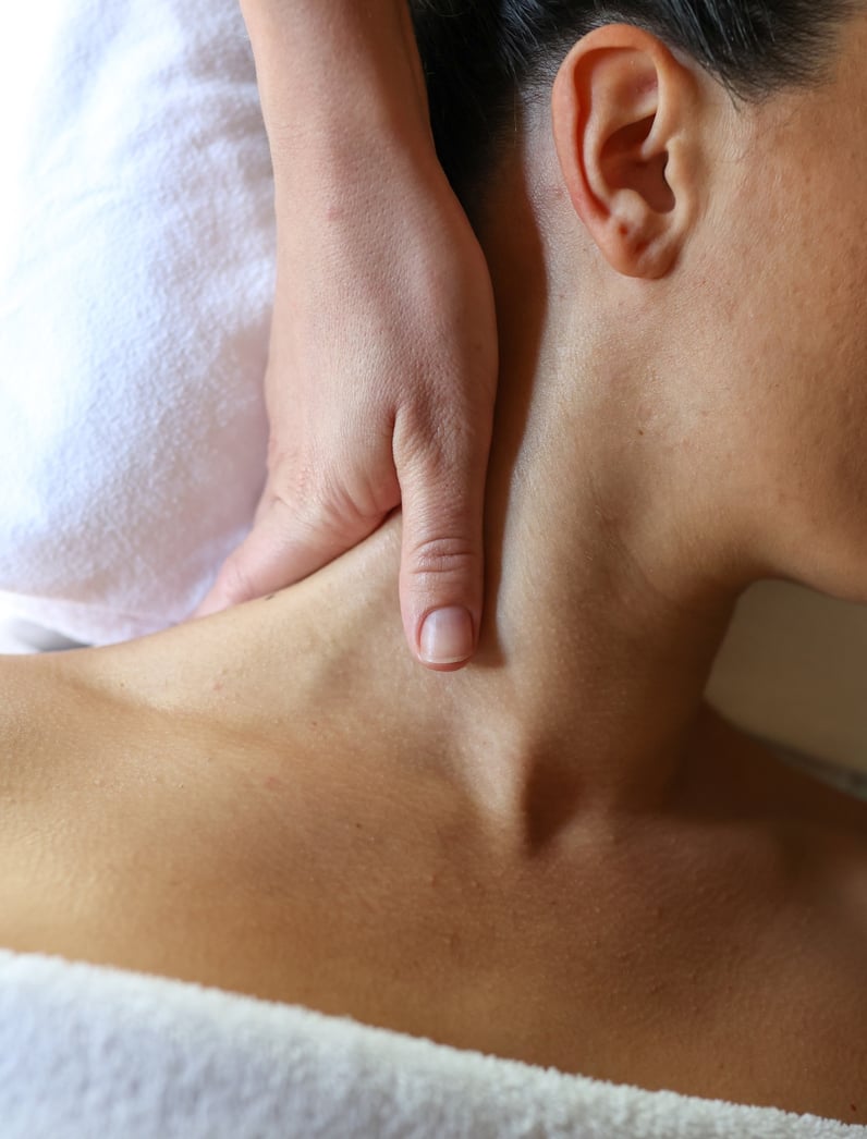 A woman receiving a neck massage