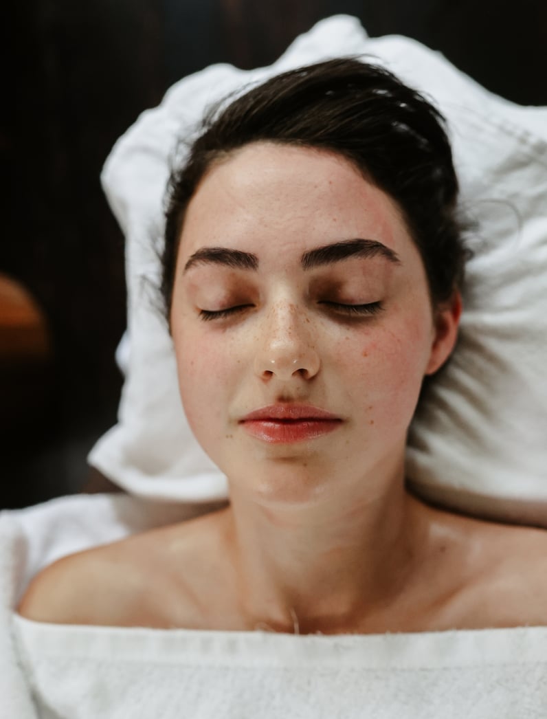 A young woman lying on a massage bed