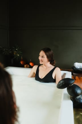 A woman bathing in a ceramic private bath